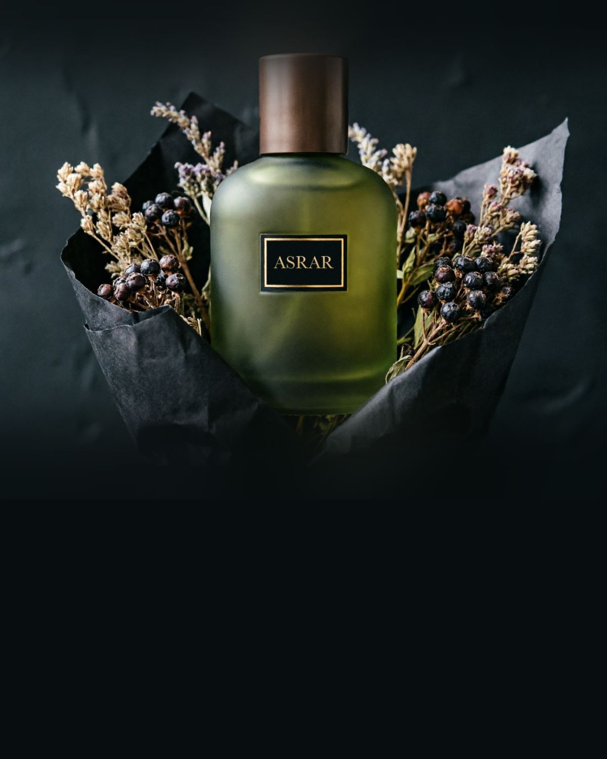 A perfume bottle wrapped in black paper with dried herbs